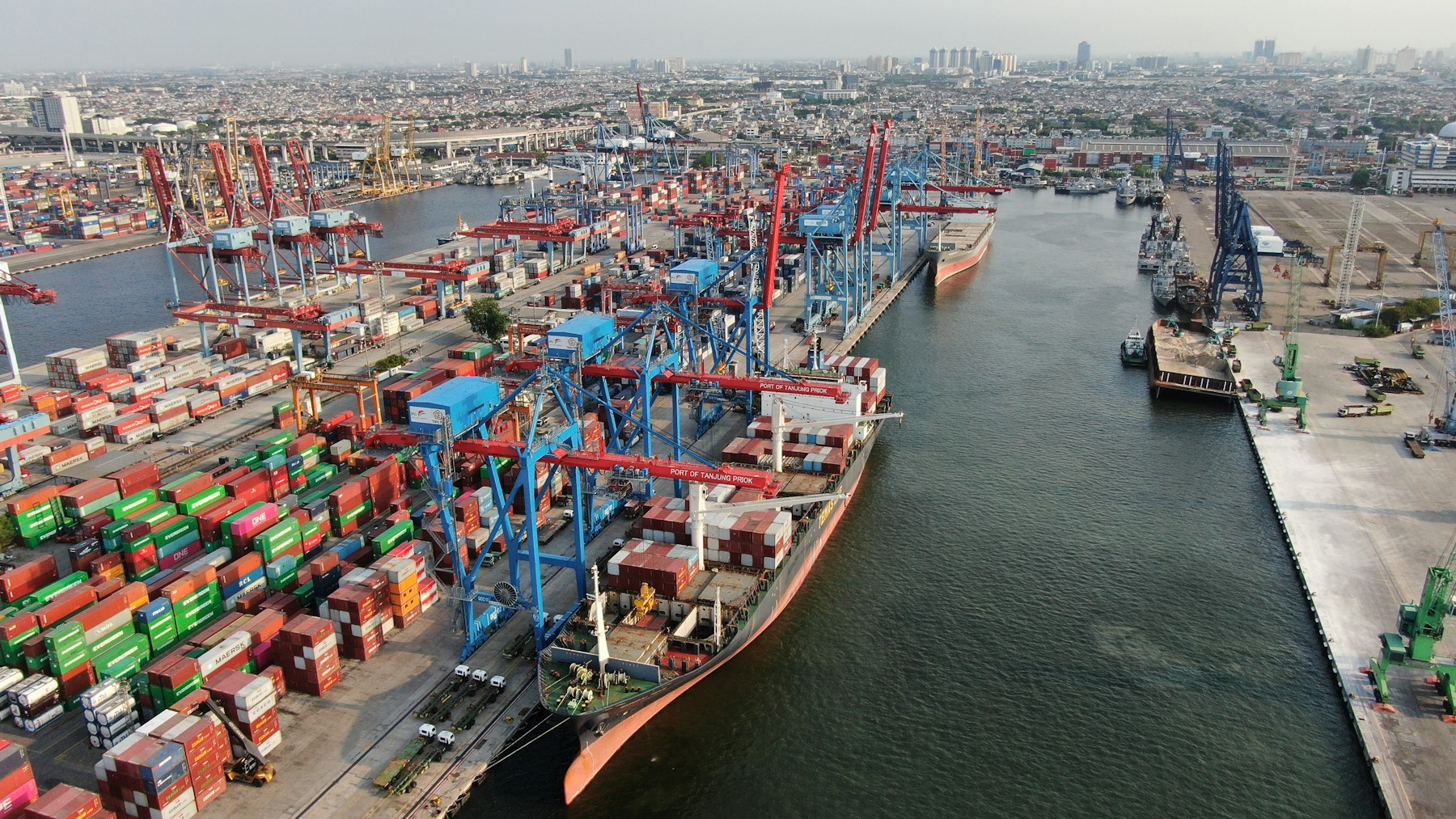 Cargo ship, containers and cranes at a busy international port